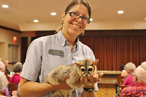 Educator Robin holds a ringtail